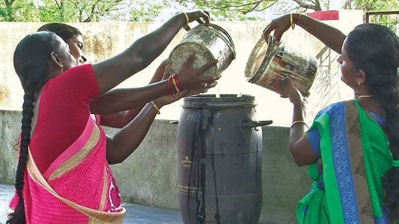 Women preparing biopesticides at a cottage industry.