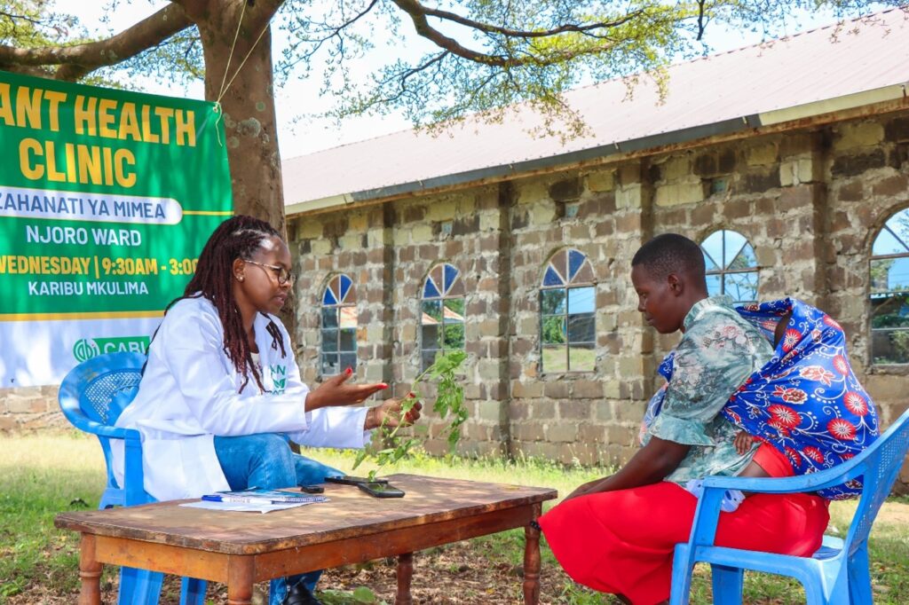 Florence Malemba advising a farmer