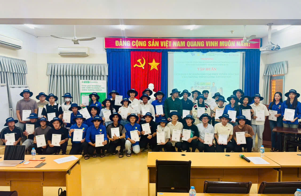 Group photo of students from An Giang University proudly displaying their CABI Academy certificates and PlantwisePlus hats, awarded for their active participation and achievement.
