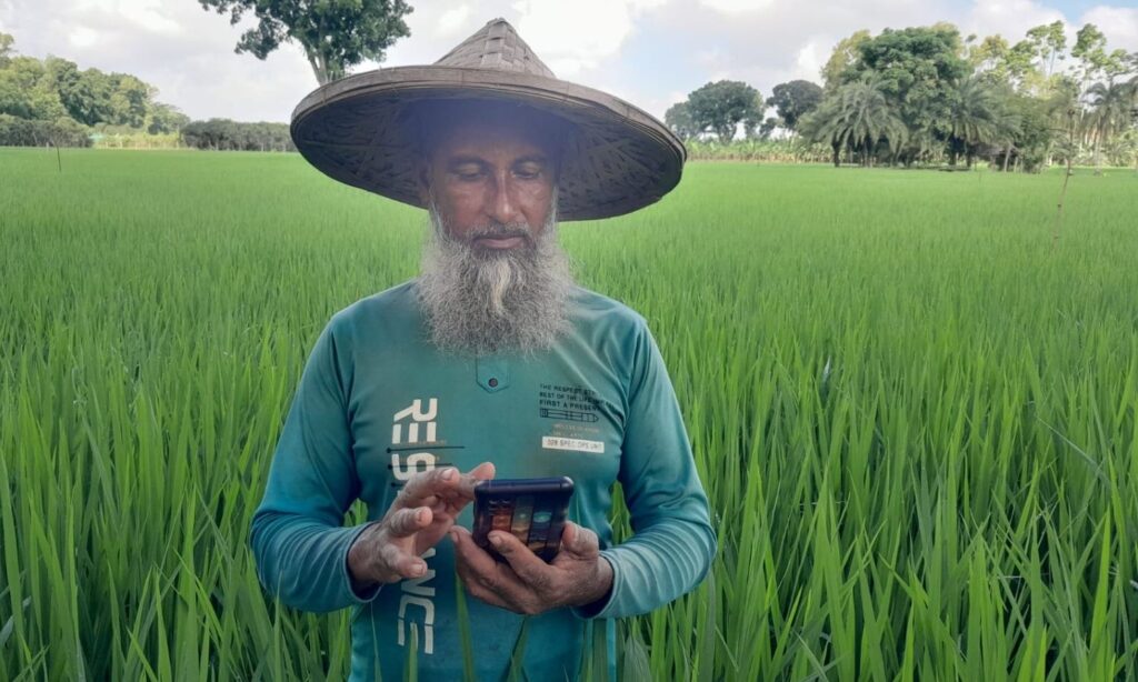 Farmer in his field using his mobile phone