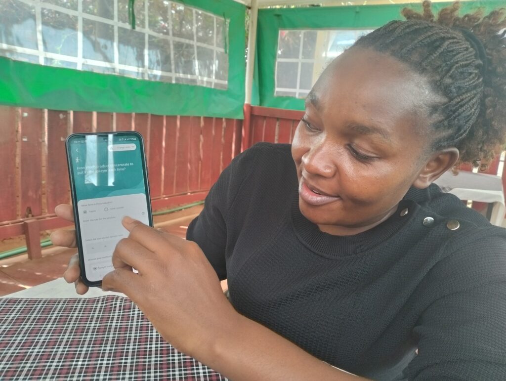 Wanza Simon, a agripreneur, using the Crop Sprayer app