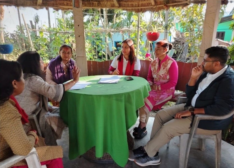 A group of people sitting round a table.