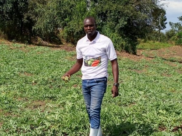 Robben, an agro-input dealer in Uganda, in a field