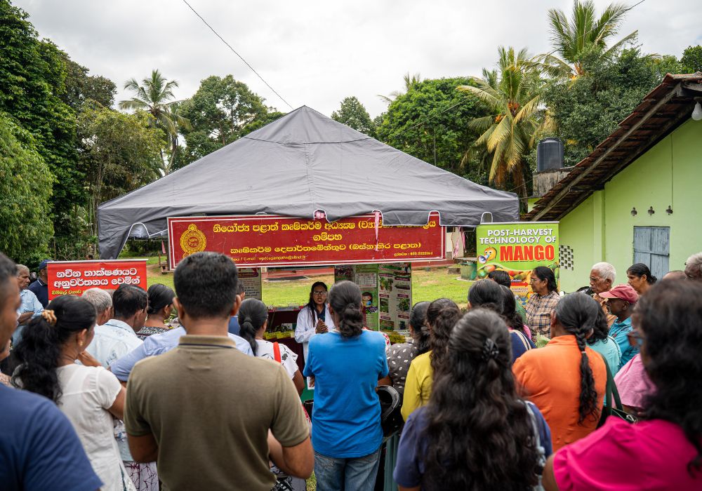 Farmers in Kandy watching a plant doctor give a talk at a plant clinic
