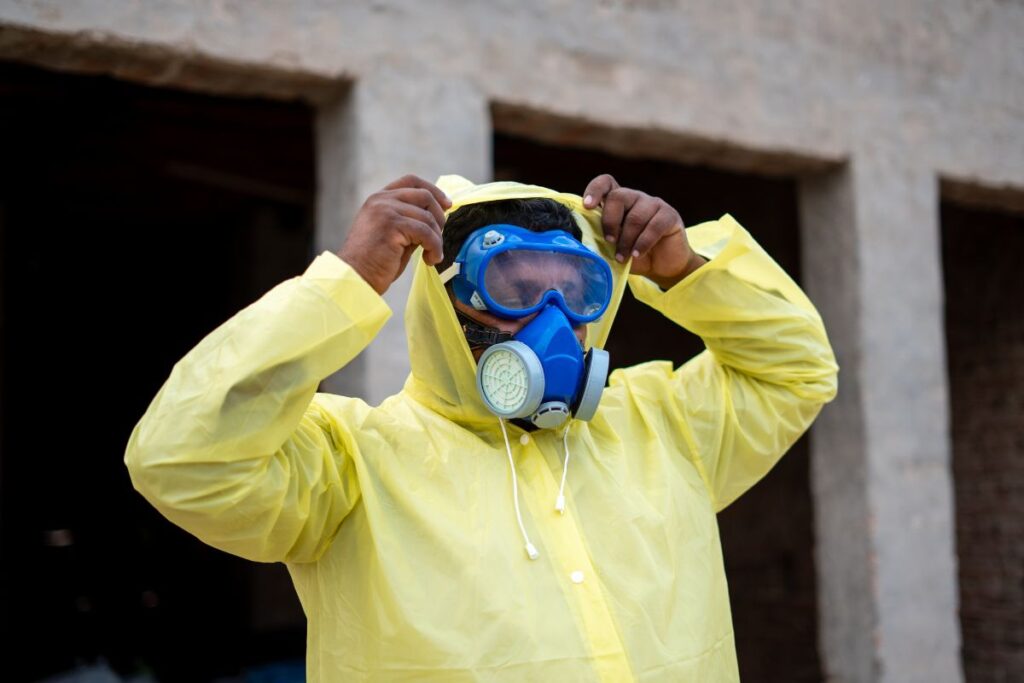 Someone putting on PPE.