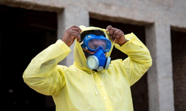 Someone putting on PPE.