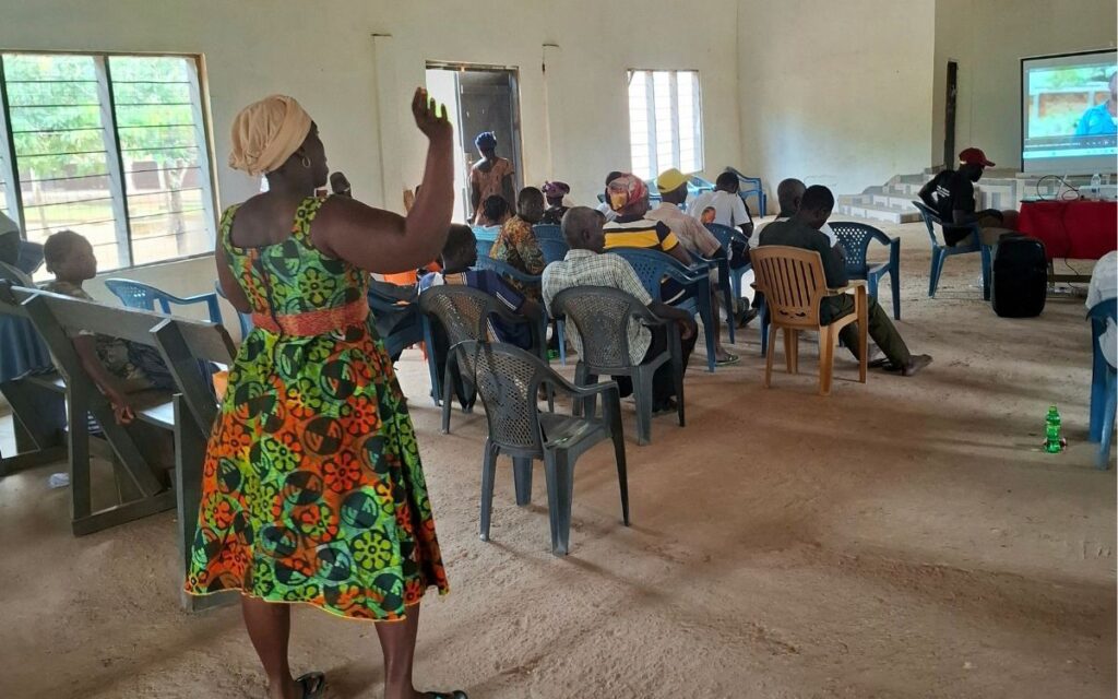 A female dialogue participant making a contribution to a discussion on pesticide safety.