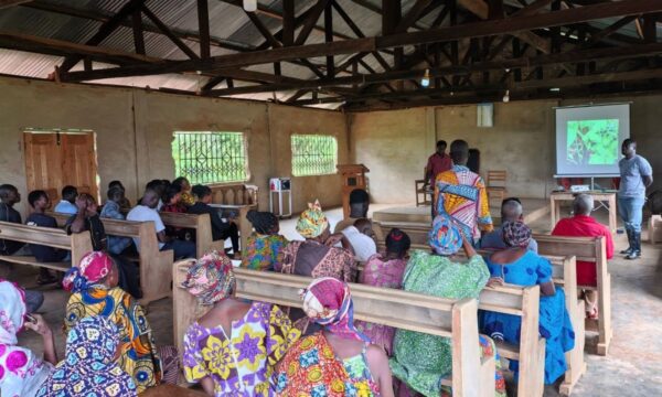 Participants at a pesticide safety event in Ghana watching a video